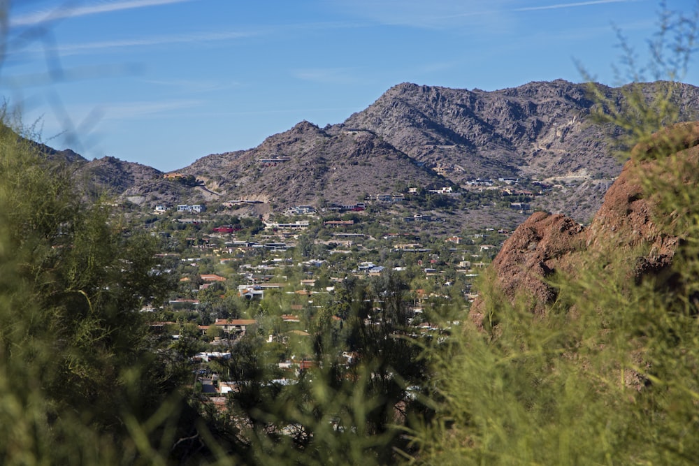 a view of a city in the distance with mountains in the background