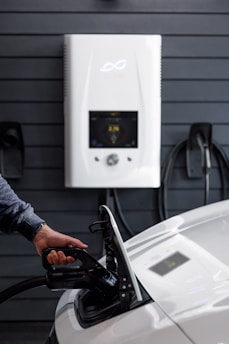 a man pumping gas into a car at a gas station