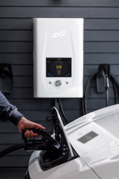 a man pumping gas into a car at a gas station