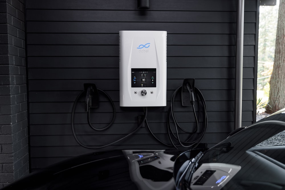 an electric car plugged in to a charge station