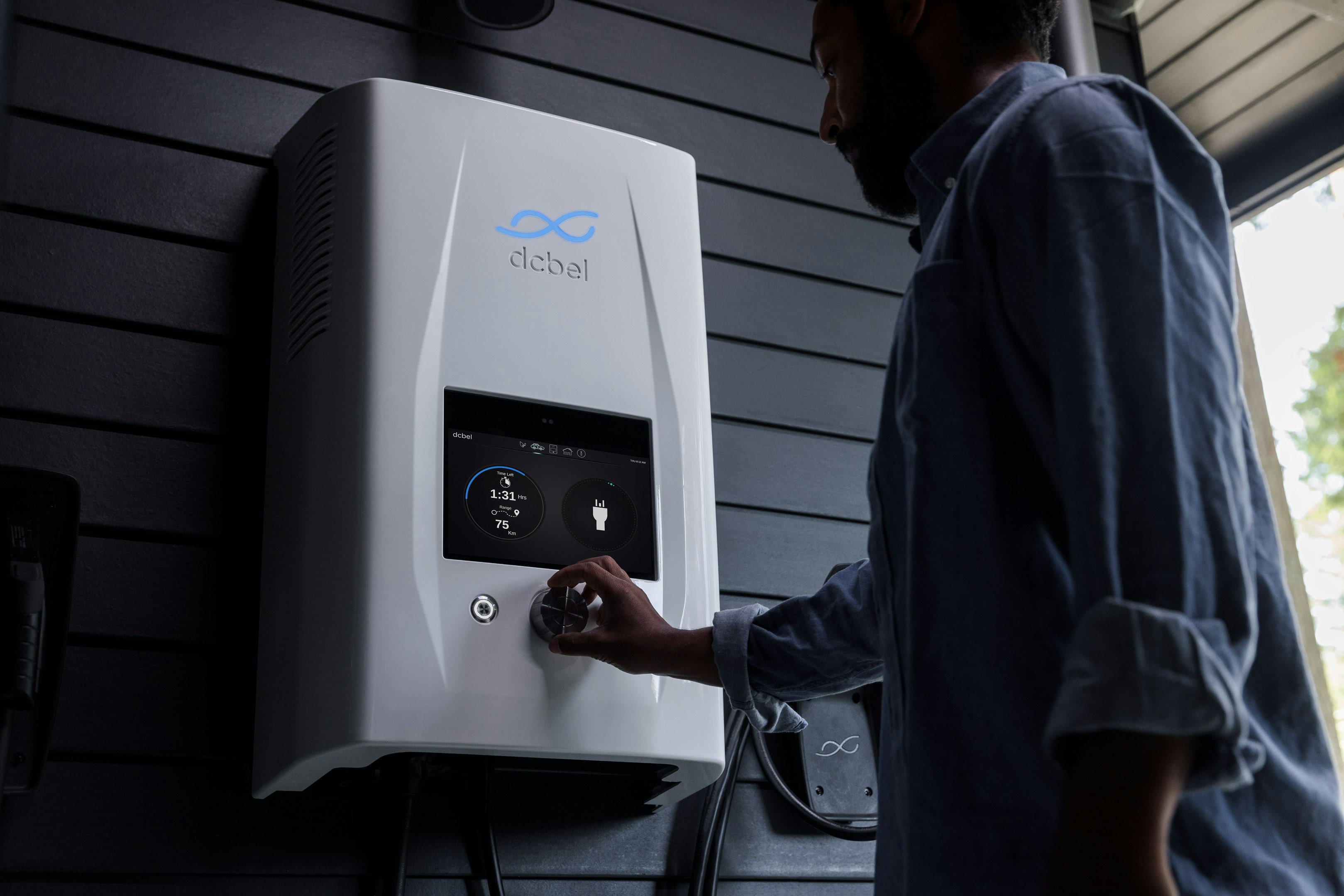 a man standing next to a white water heater