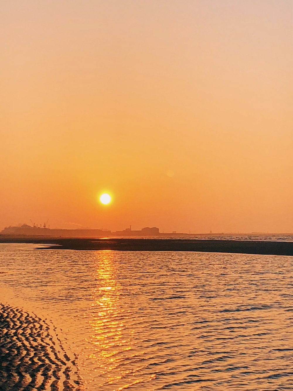 a sunset over a body of water