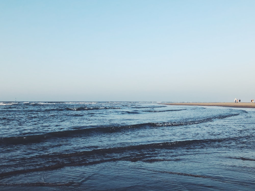 a body of water with waves coming in to shore