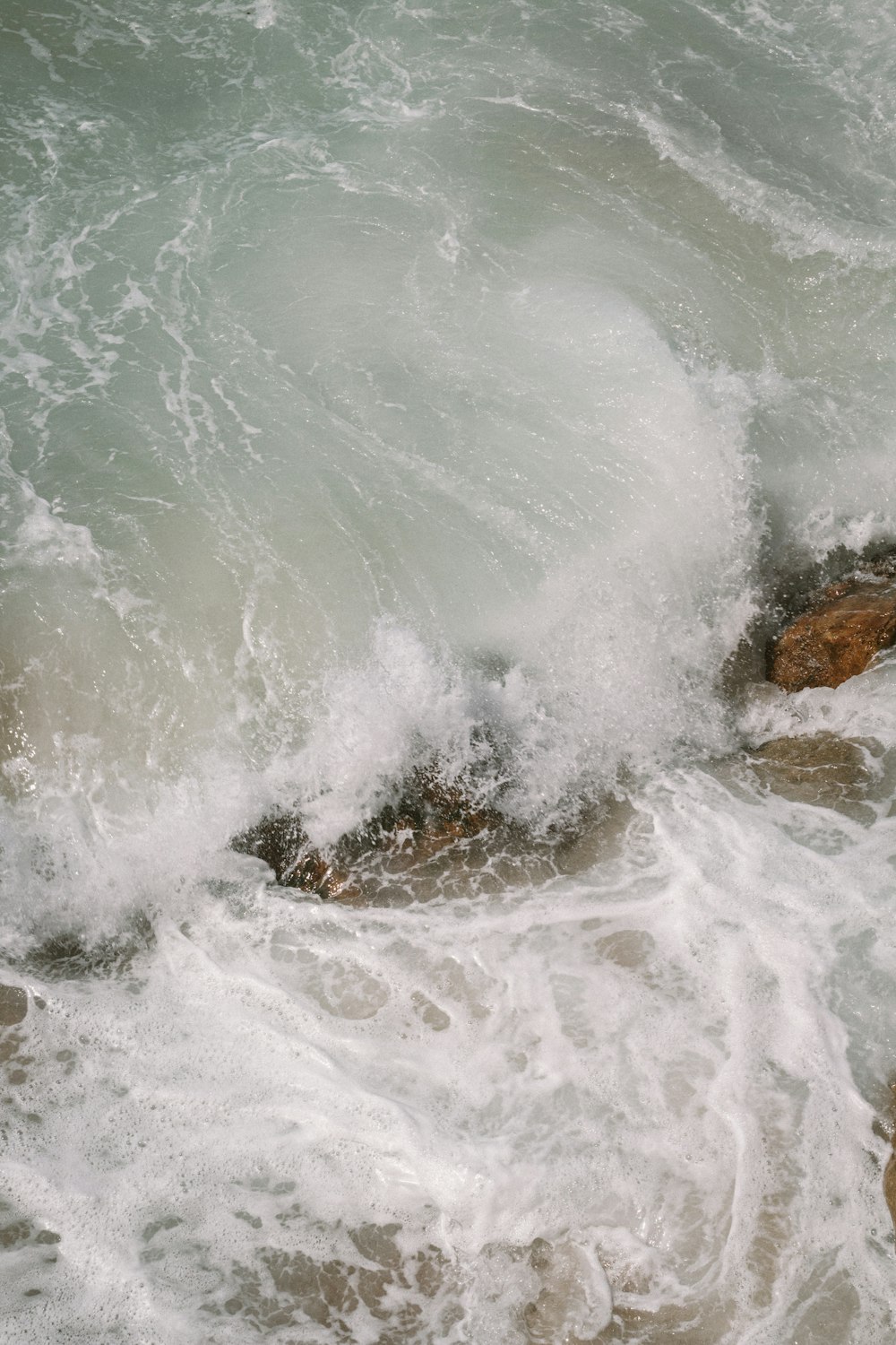 a man riding a surfboard on top of a wave in the ocean