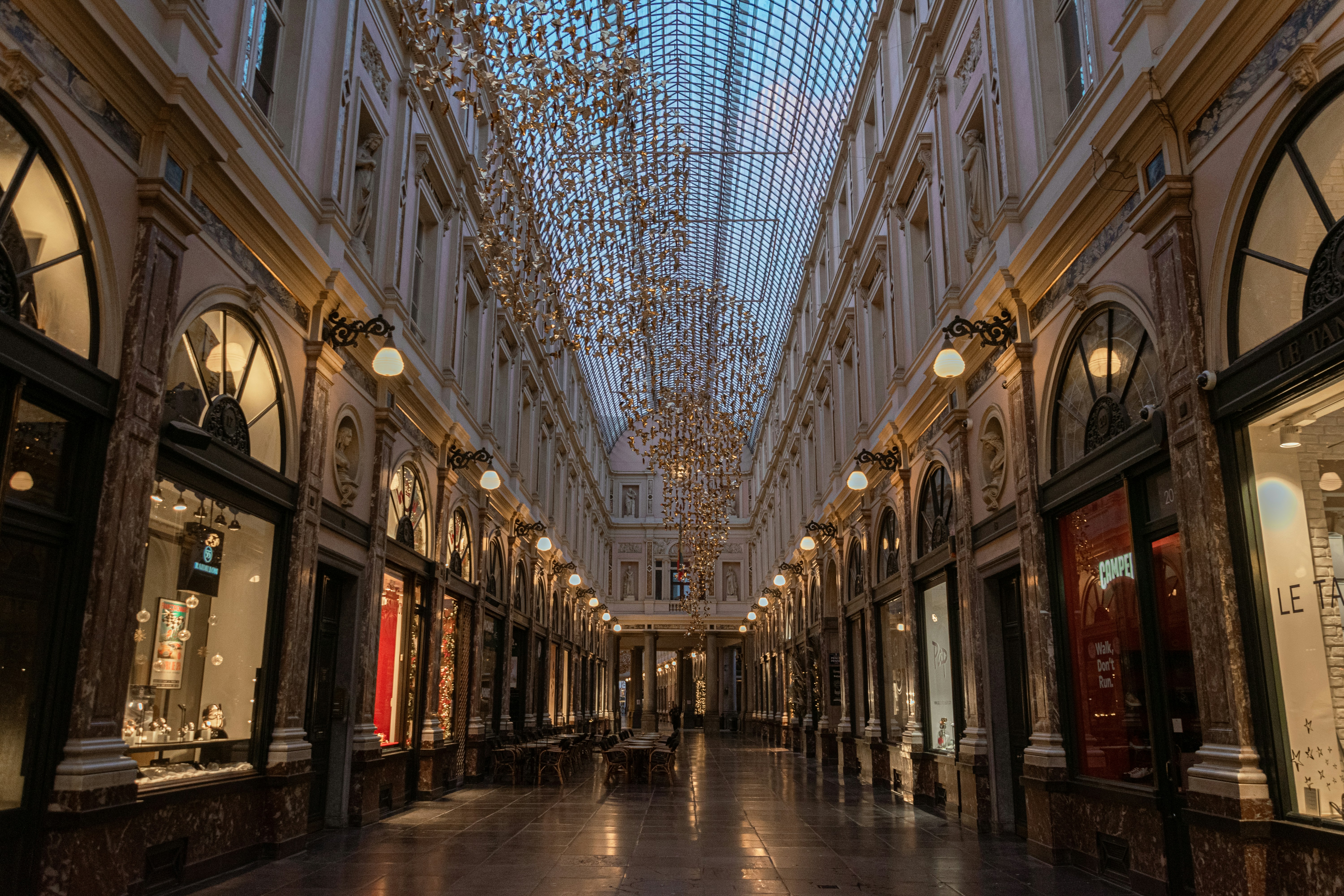 an empty shopping mall with chandeliers hanging from the ceiling