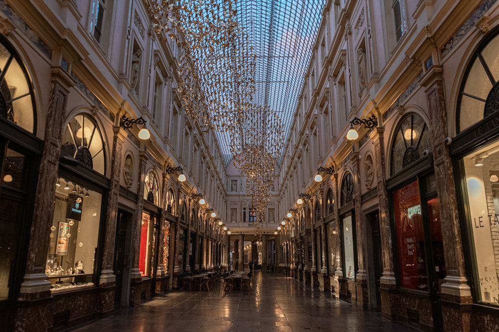 an empty shopping mall with chandeliers hanging from the ceiling