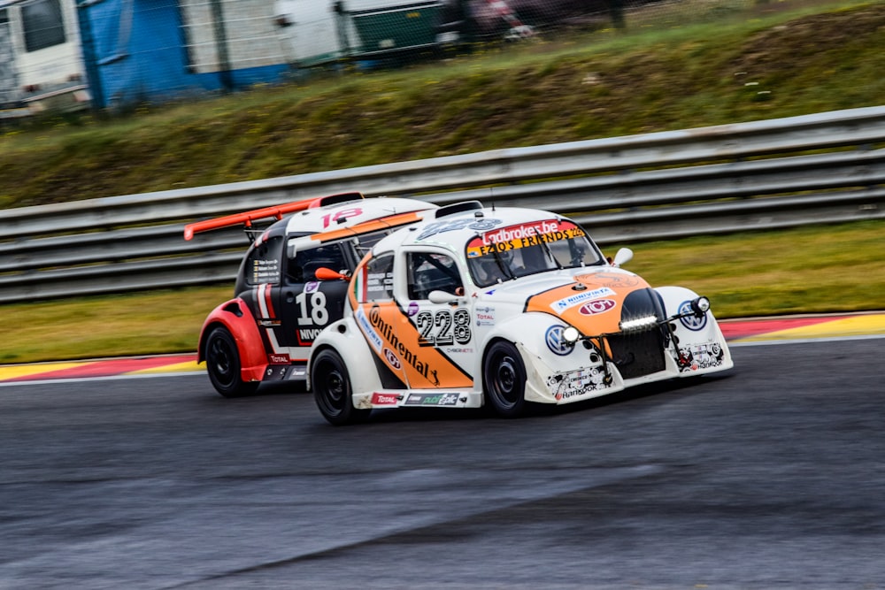 a white and orange car driving down a race track