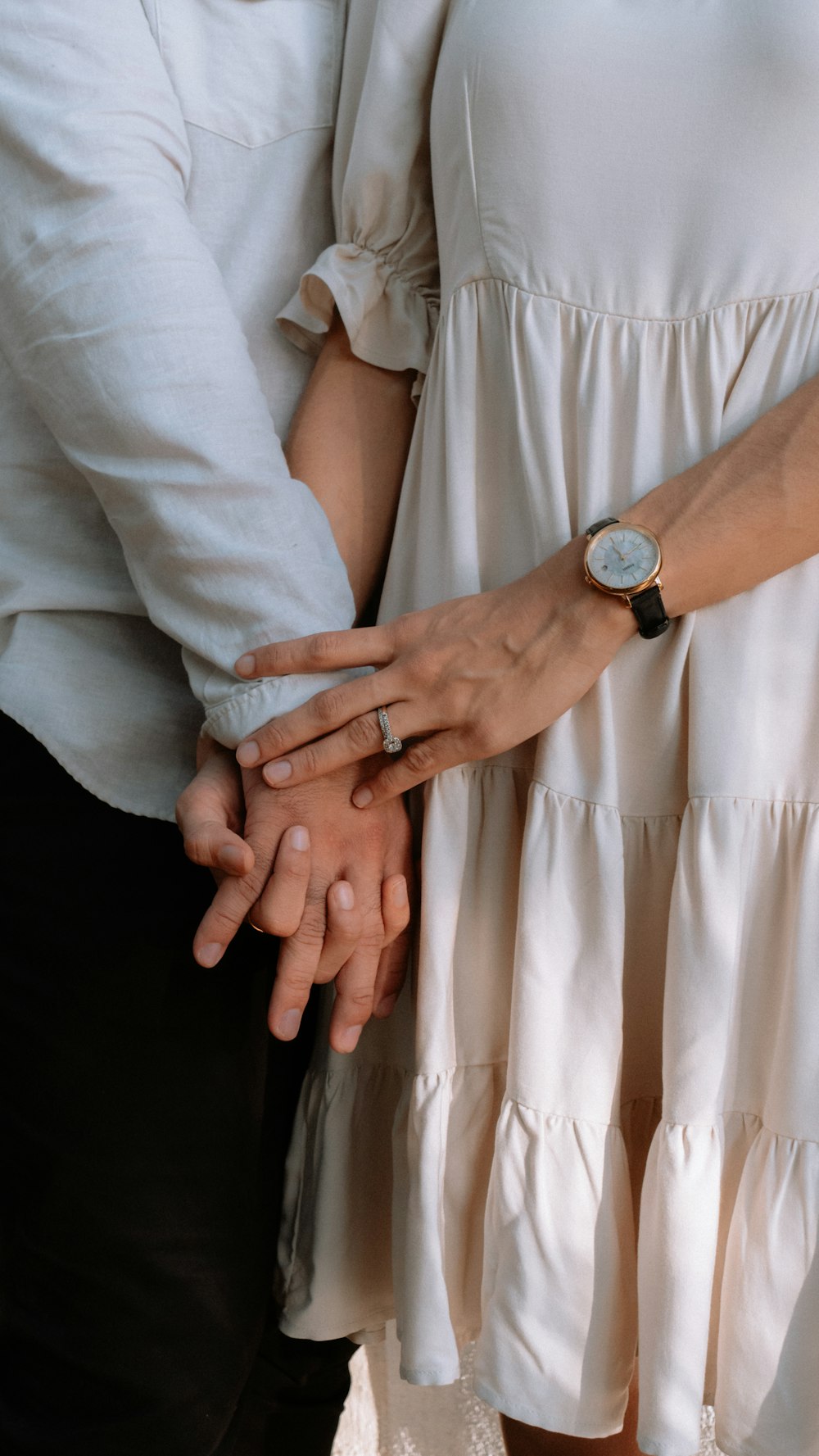 a close up of a person holding the hand of another person