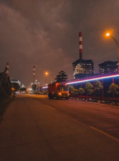 Night shot of illuminated industrial park with trucks