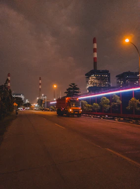 Night shot of illuminated industrial park with trucks