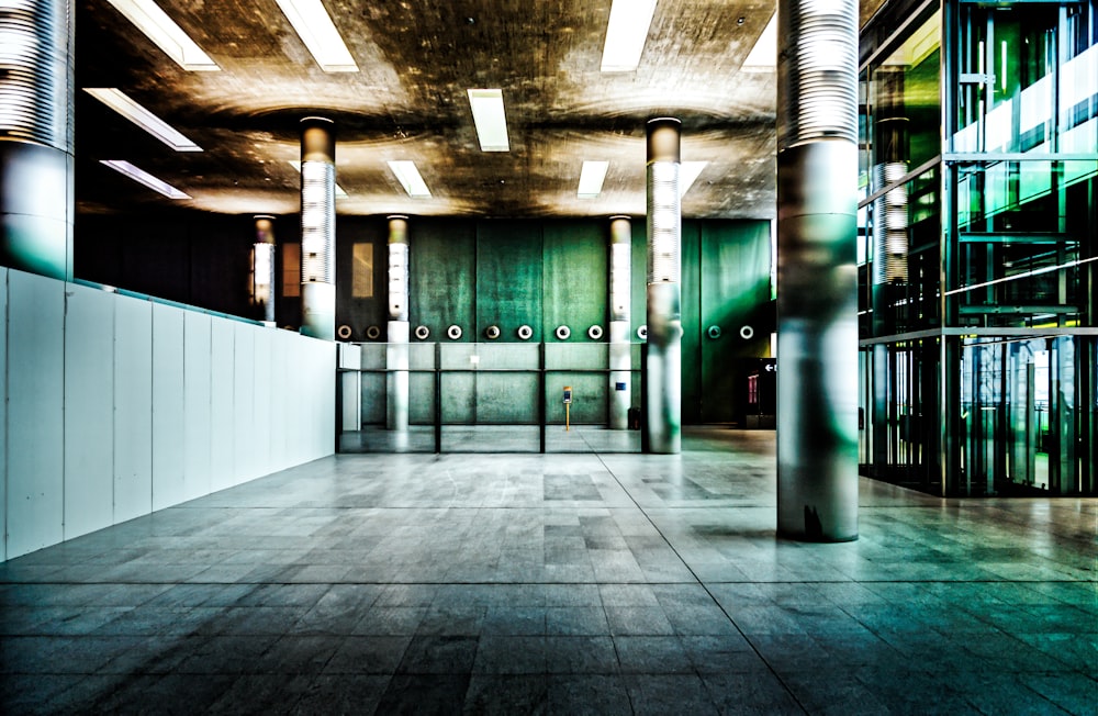 an empty room with columns and lights in it