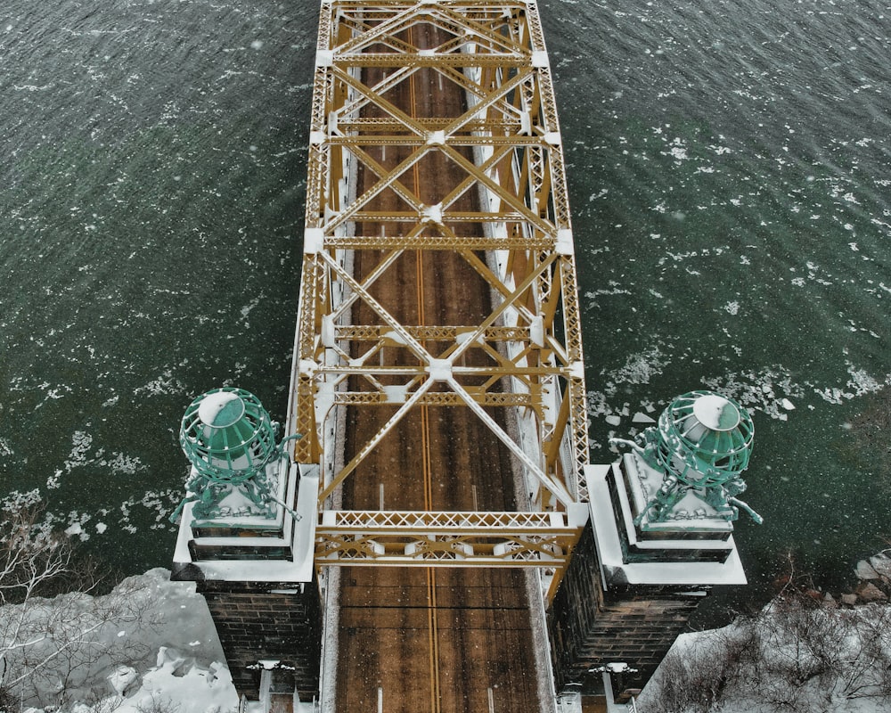 an overhead view of a bridge over a body of water