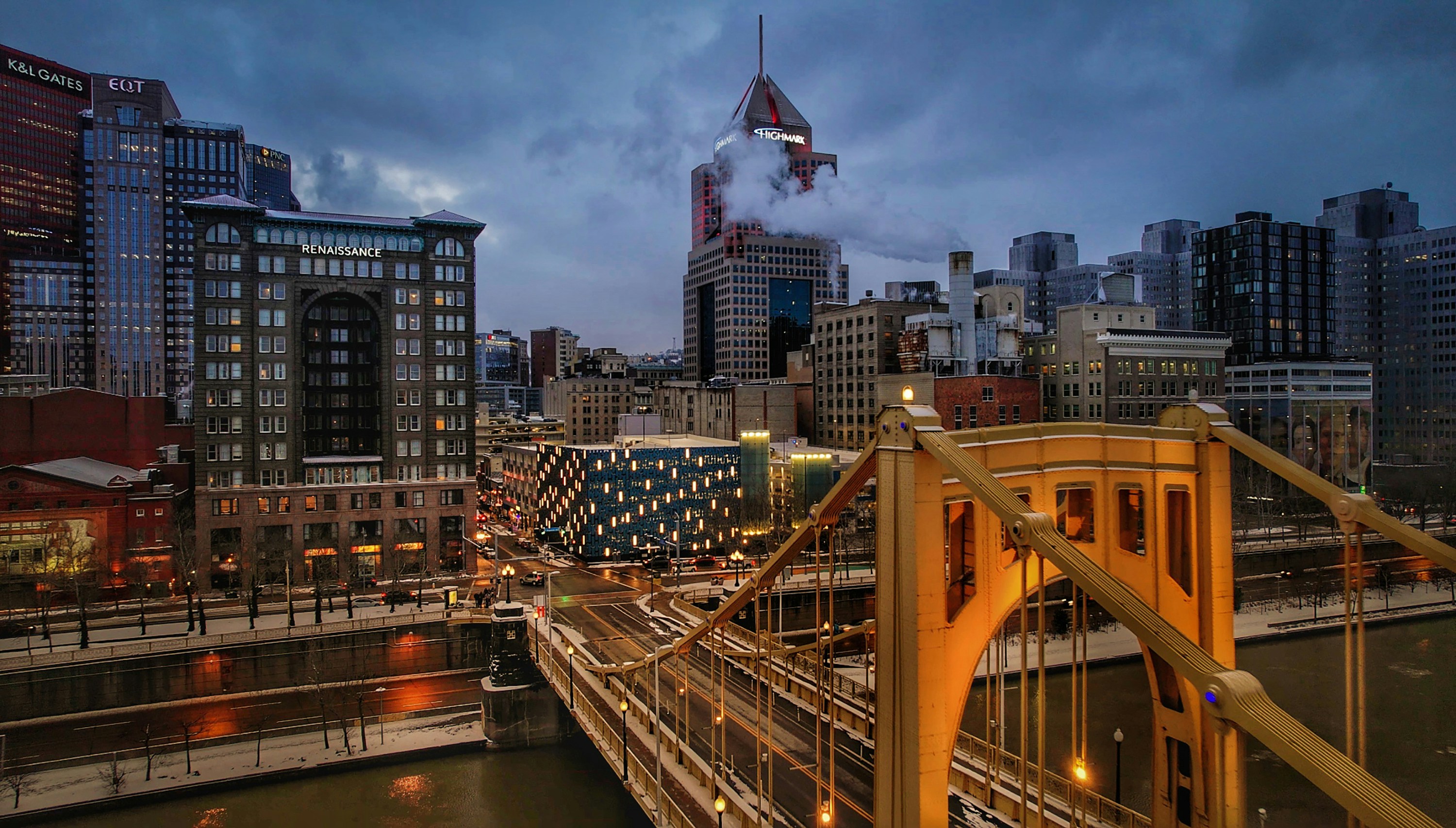 a view of a city with a bridge in the foreground