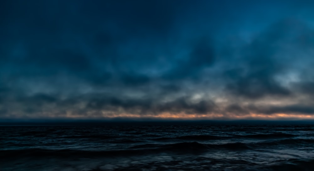 a cloudy sky over a body of water