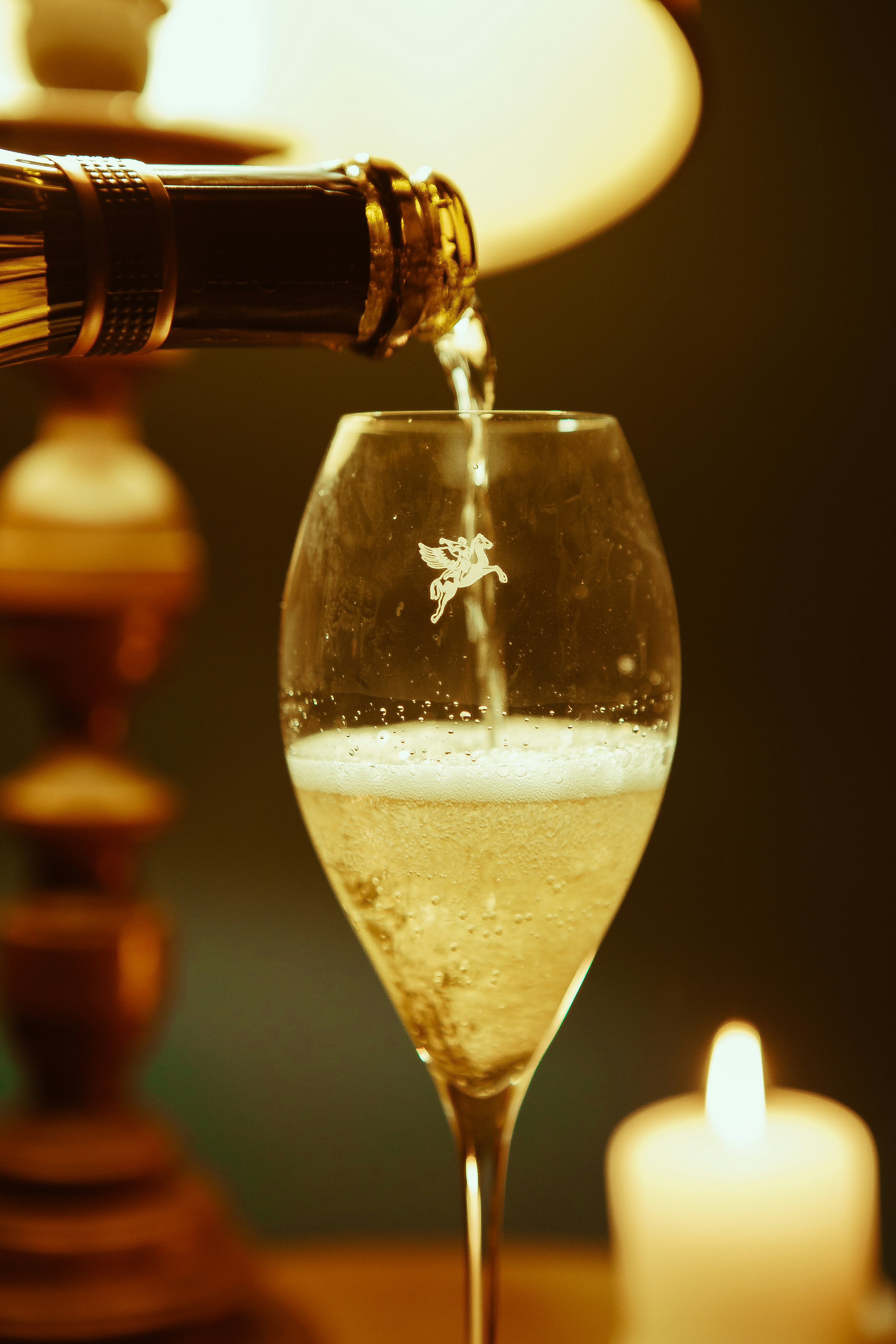 a bottle of wine being poured into a wine glass