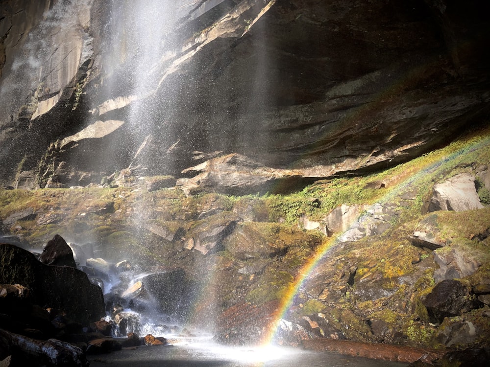 a waterfall with a rainbow in the middle of it