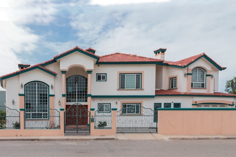a pink and white house with a red roof