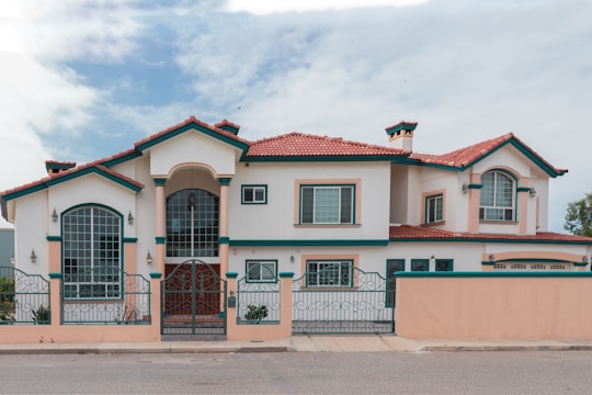 a pink and white house with a red roof