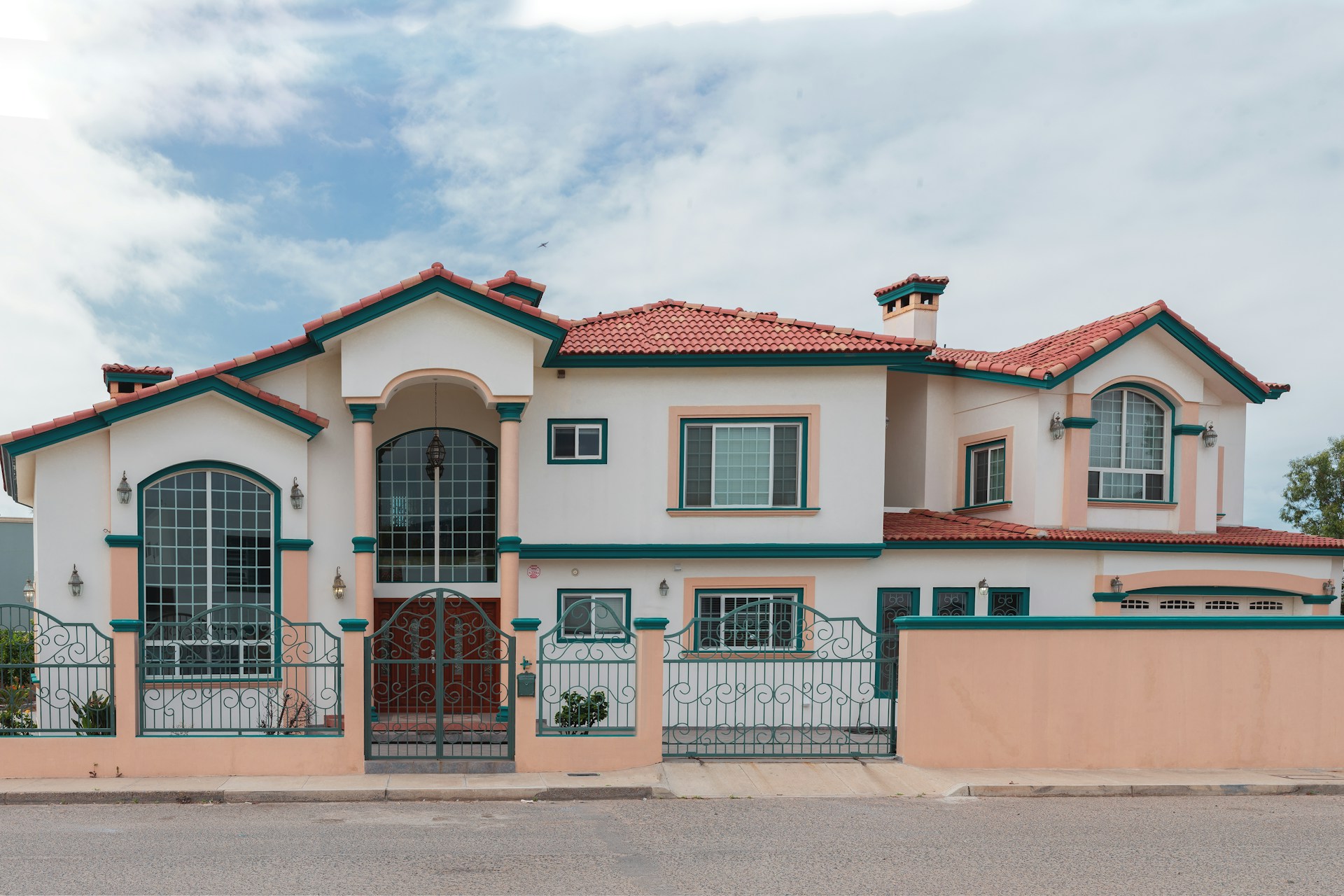 a pink and white house with a red roof