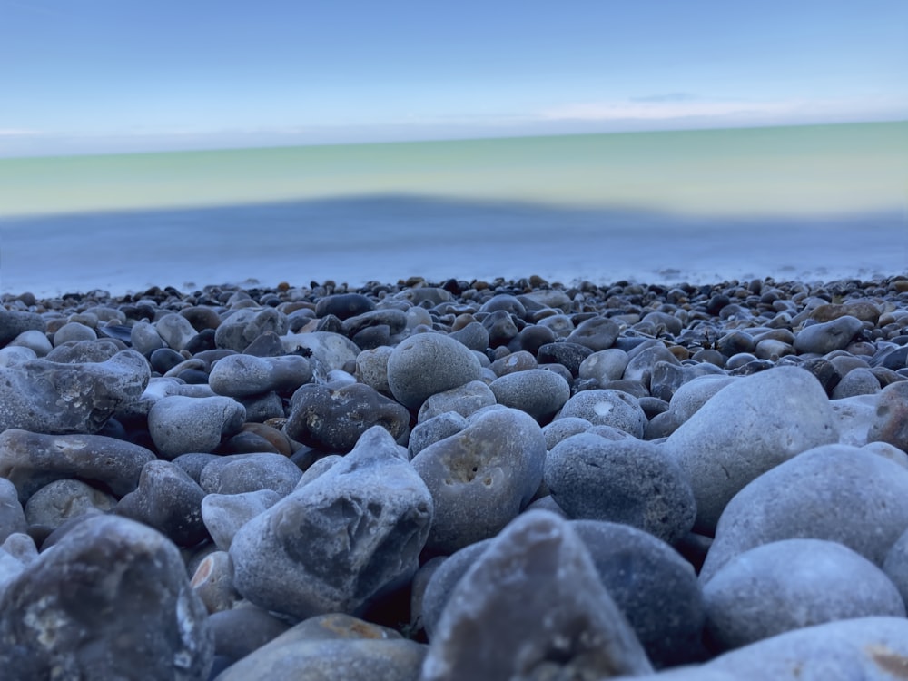 a bunch of rocks sitting on top of a beach