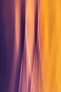 Abstract golden light rays blending into soft violet hues