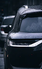 a car parked on the side of the road covered in snow