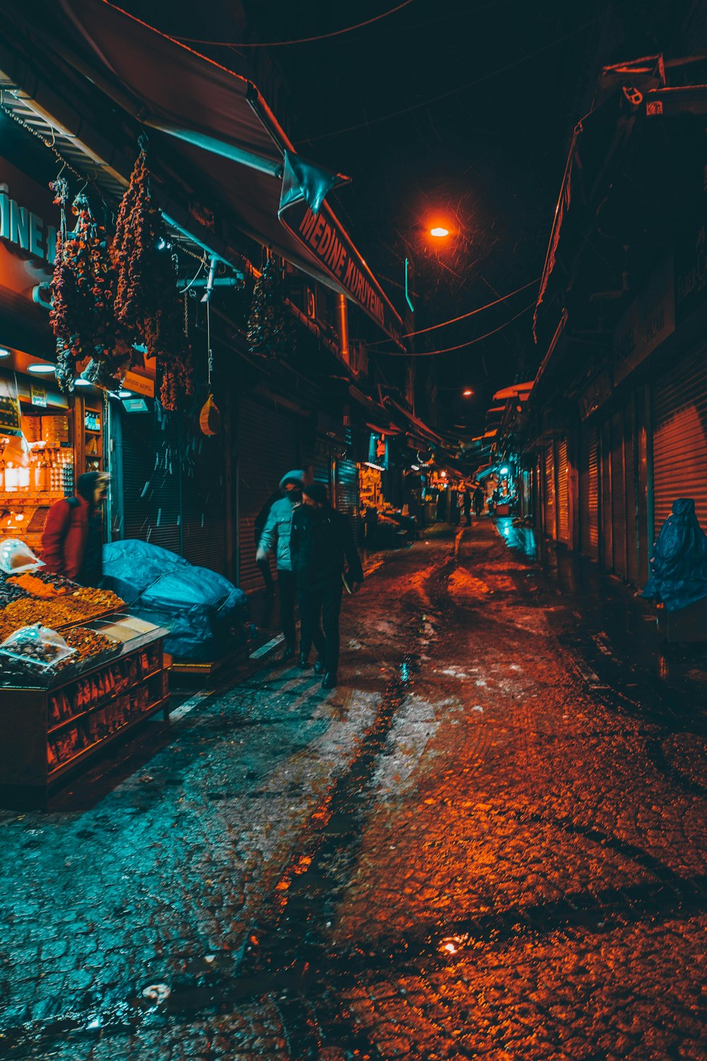 a man walking down a street at night