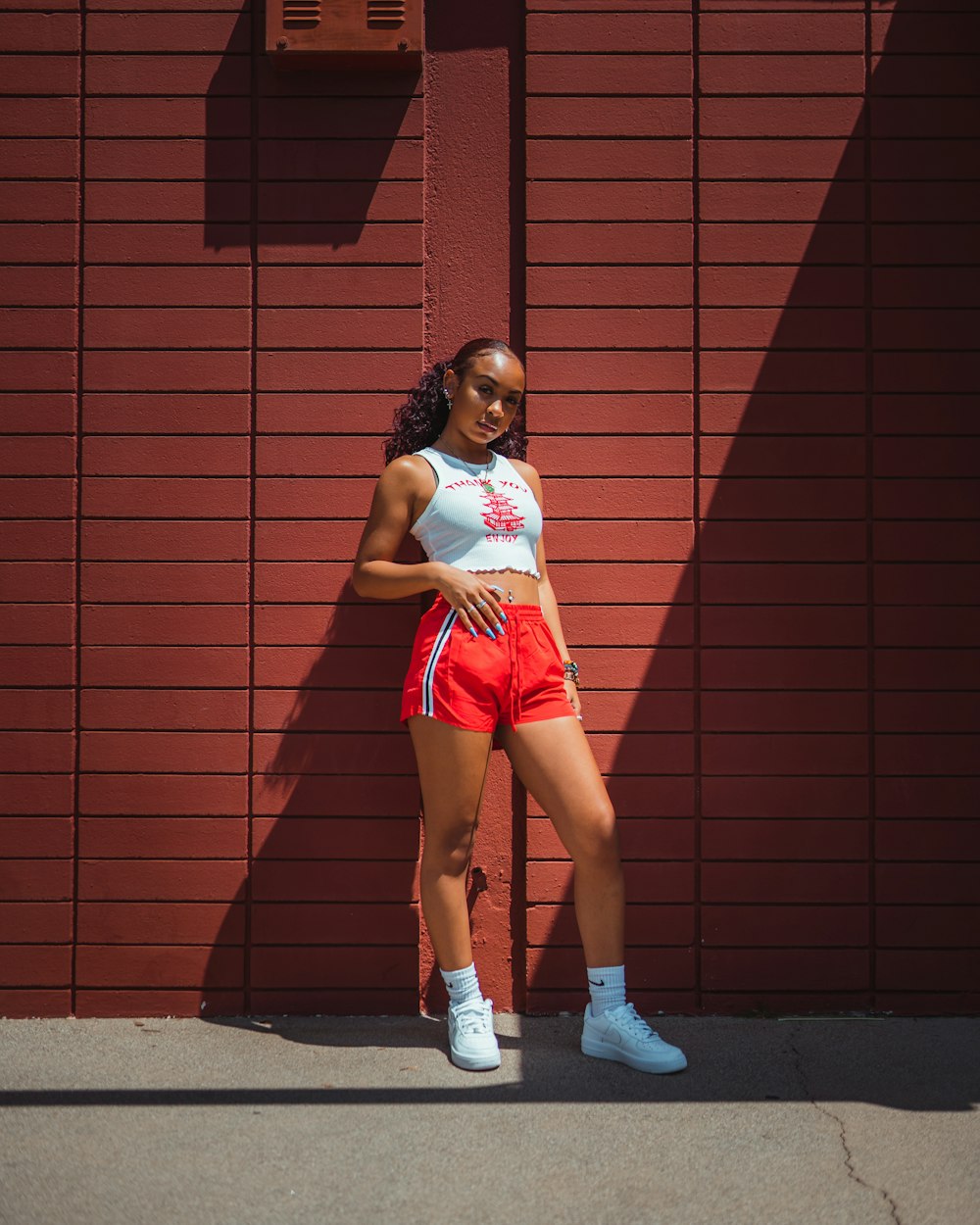 a woman standing in front of a red wall