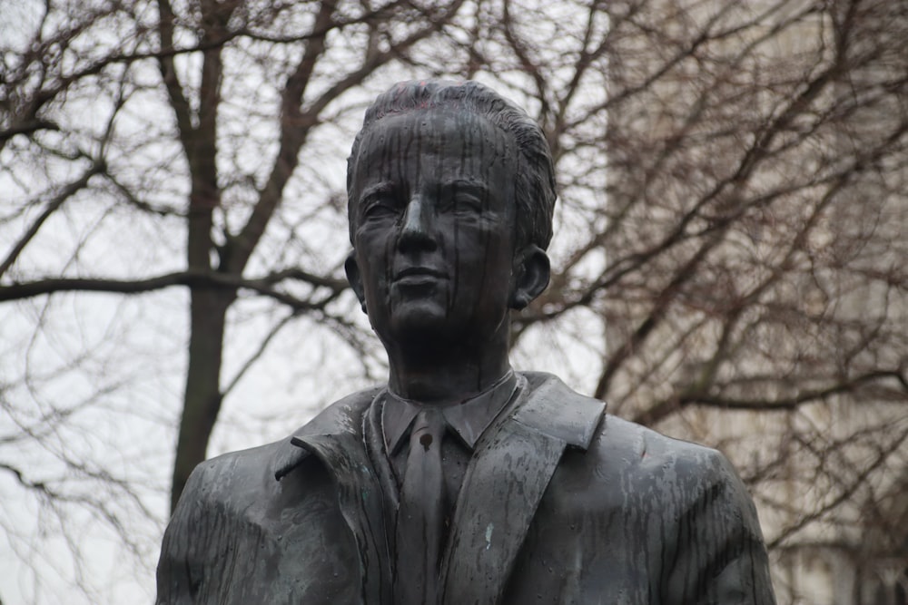 a statue of a man wearing a suit and tie