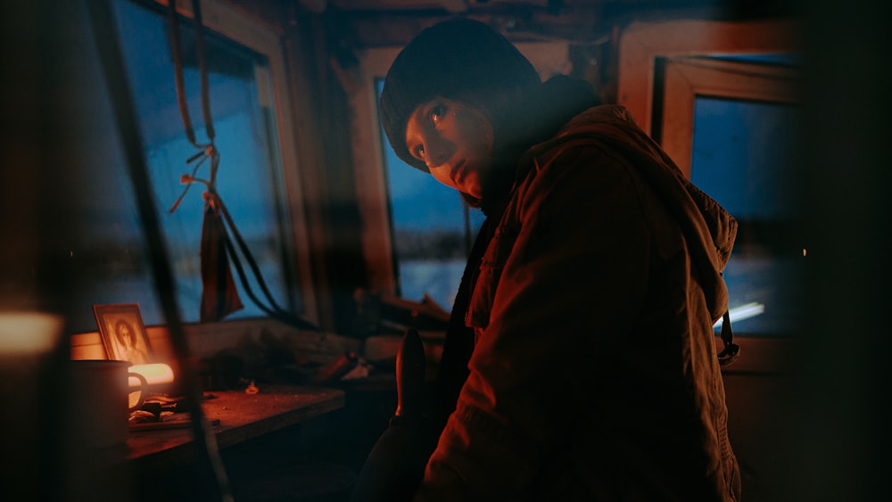 a man standing next to a window in a room