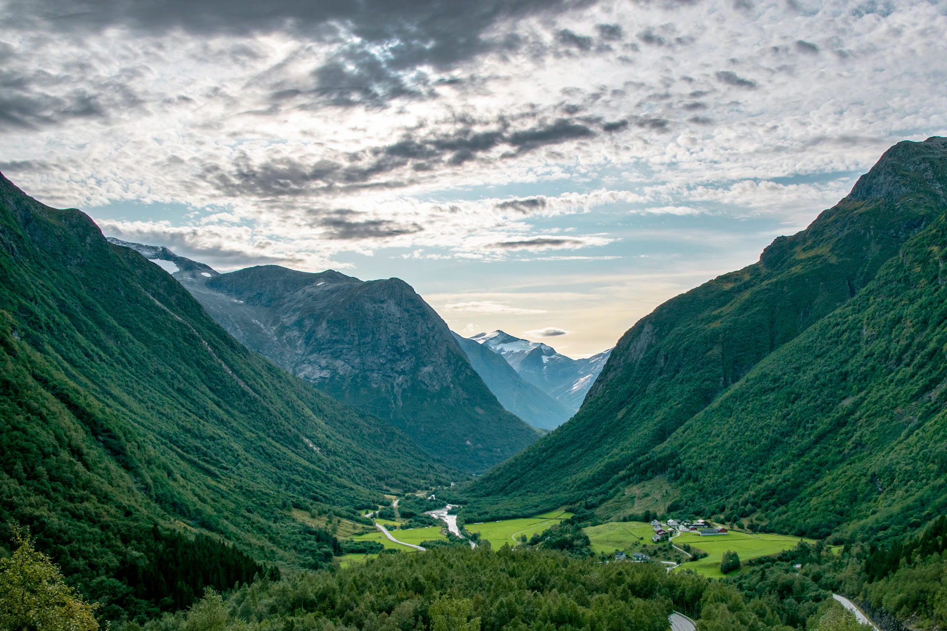 a view of a valley with mountains in the background