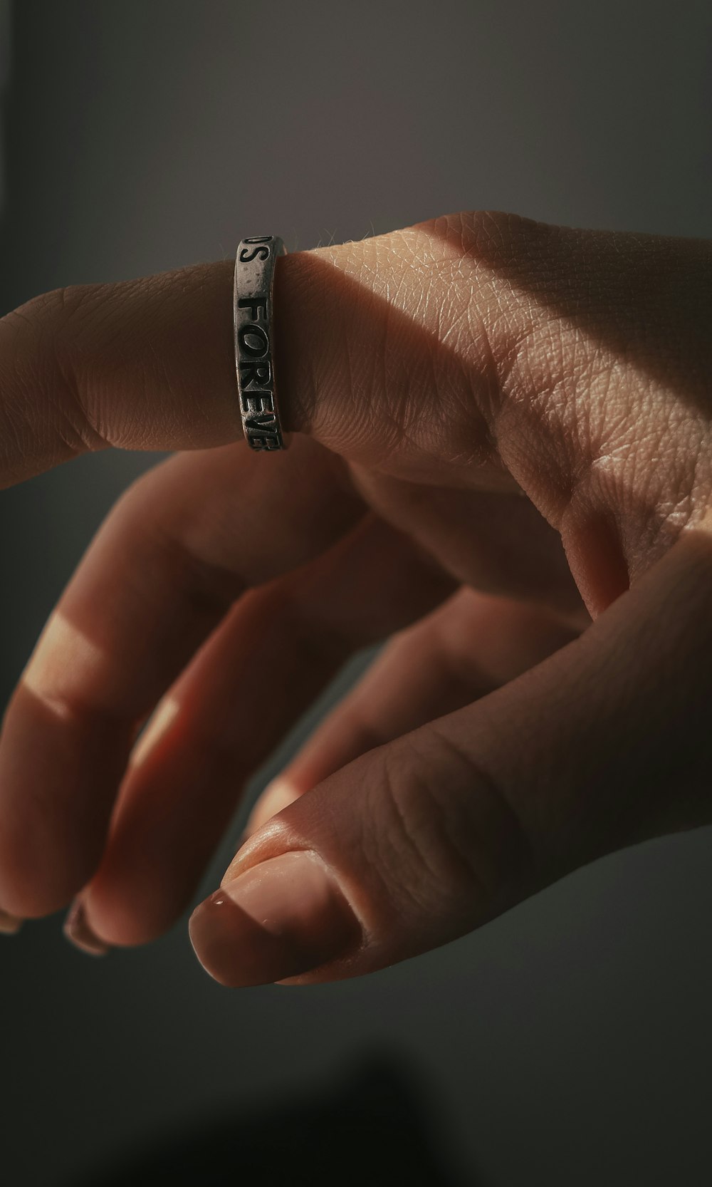 a person's hand with a ring on it