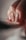 A close-up of a person's hand focusing on their polished nails. The nails are painted in a glossy, neutral color with one nail featuring a hint of glitter. The lighting creates soft shadows, enhancing the textures of the fingers and nails.
