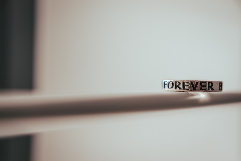 a close up of a door handle with the word forever on it