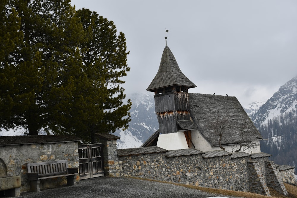 a building with a steeple and a bench in front of it