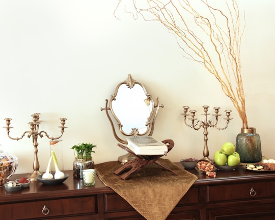 a table topped with a wooden dresser and a mirror