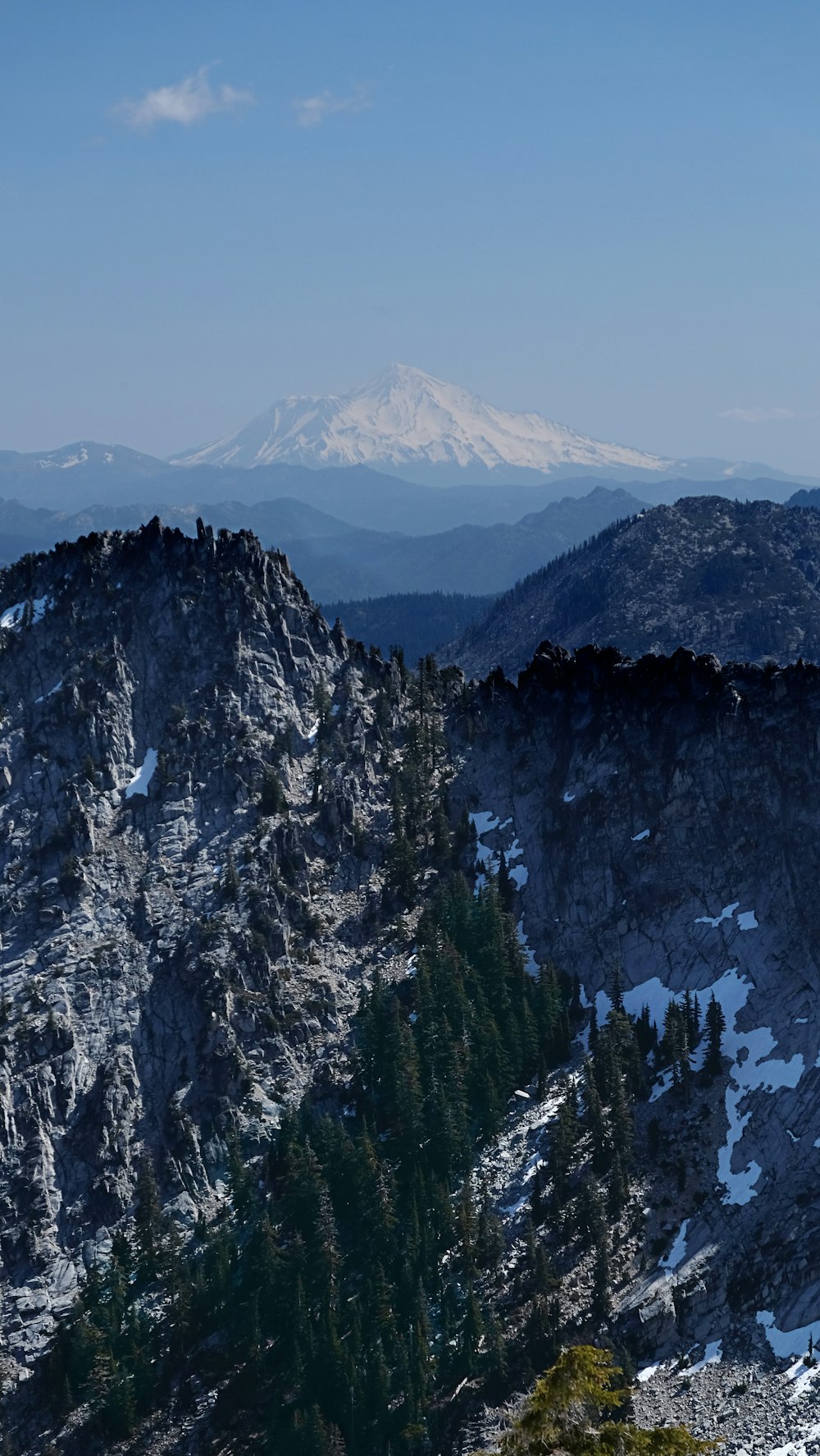 a view of a mountain range with snow on the ground