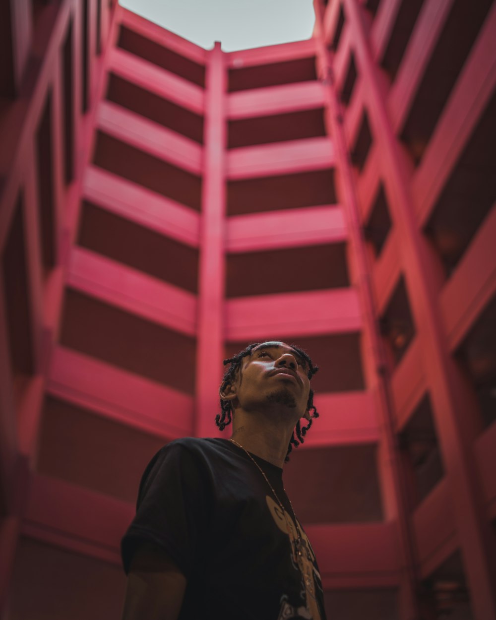 a man standing in front of a red building