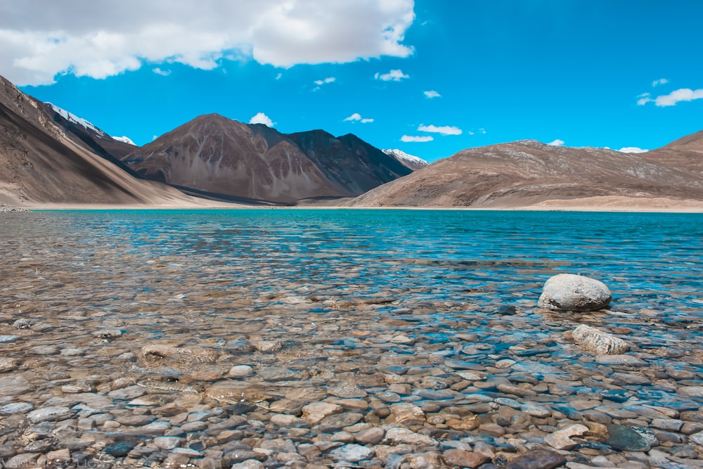 a body of water surrounded by mountains and rocks