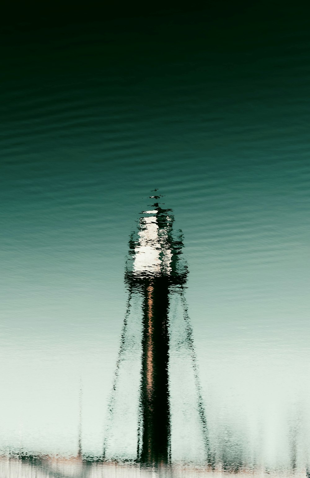 a blurry photo of a lighthouse on a beach