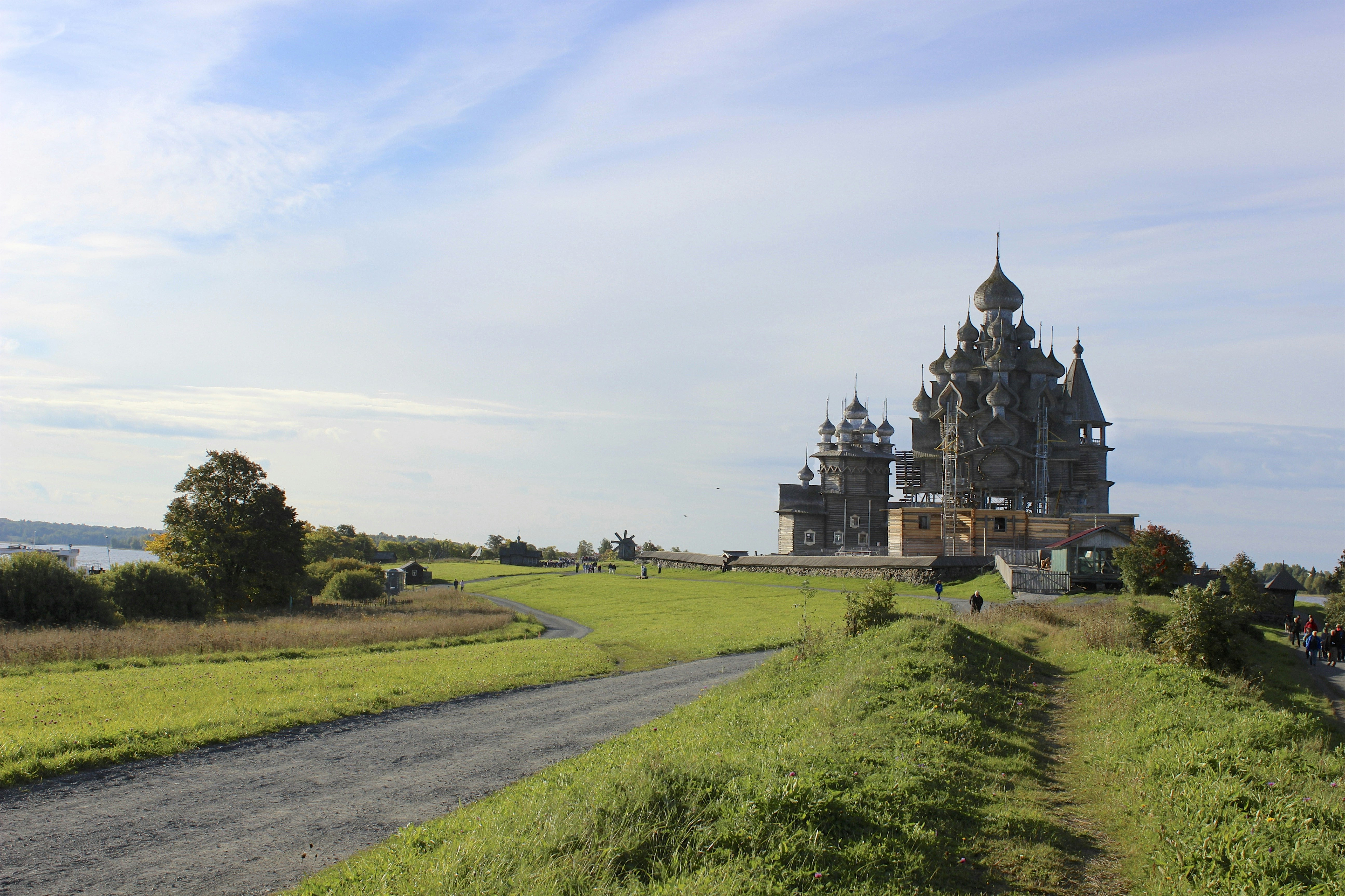 a large building sitting on top of a lush green field