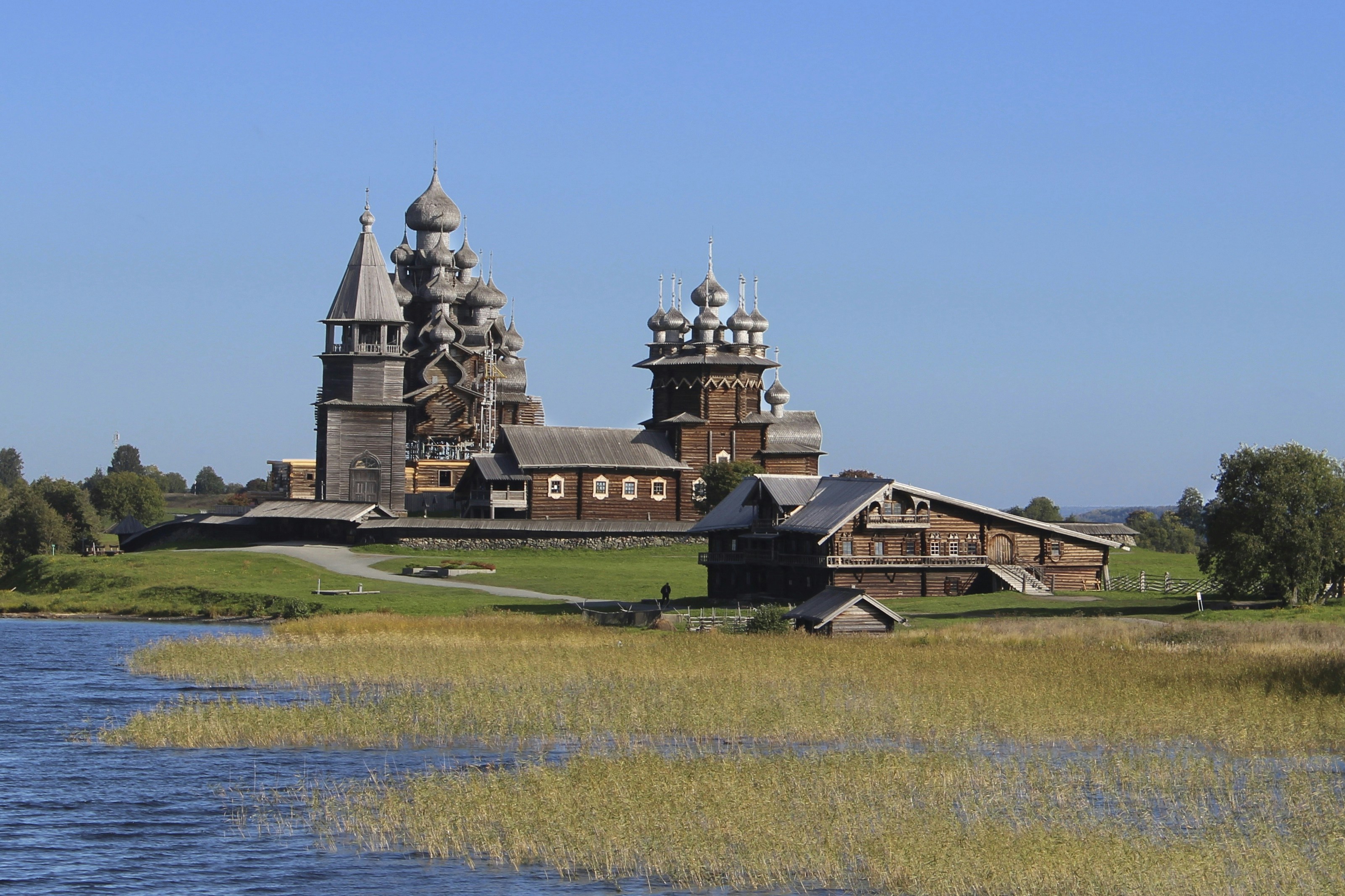 a large building sitting on top of a lush green field