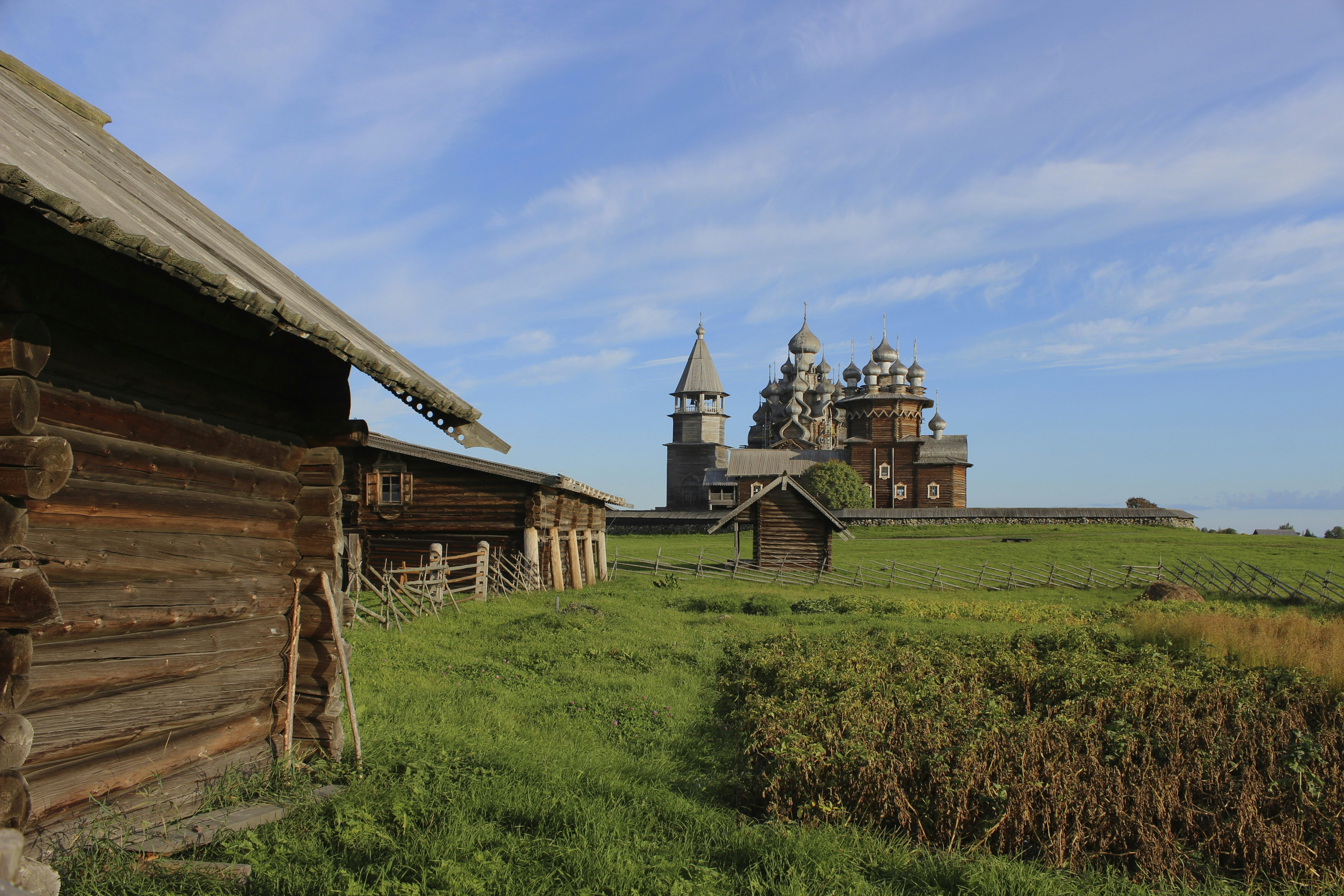a large wooden building sitting on top of a lush green field