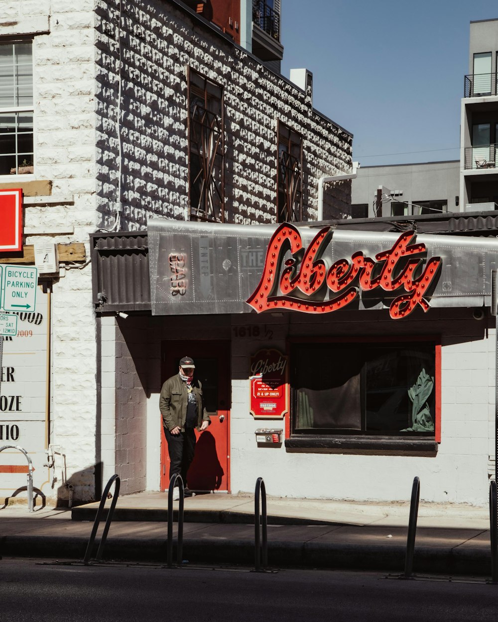 a man standing in front of a store called liberty