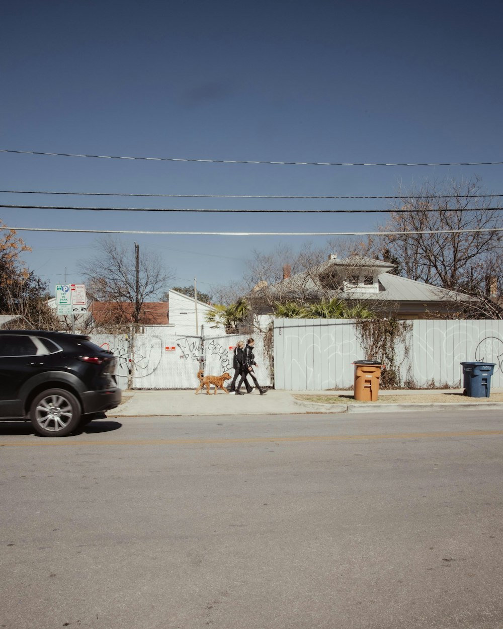 a black car parked on the side of a road