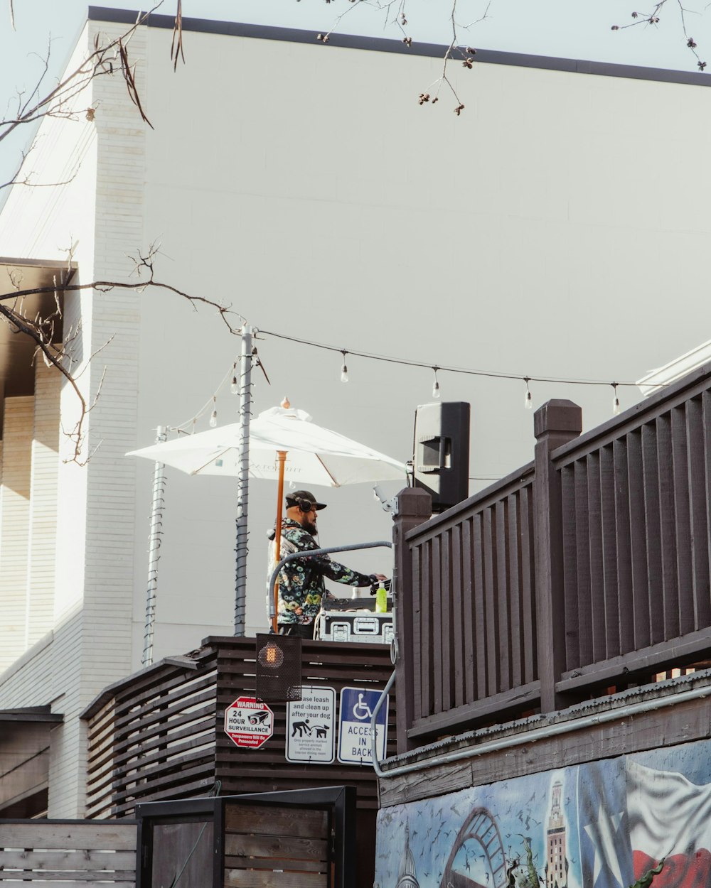 a man standing on top of a truck under an umbrella