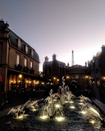 A classic European cityscape featuring the Eiffel Tower and cobblestone streets bathed in golden light.