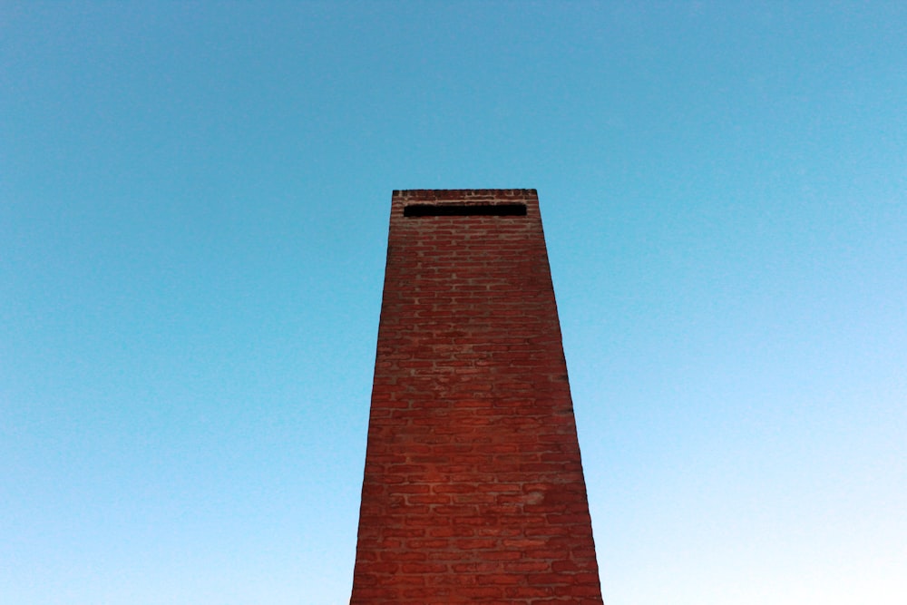 a tall brick tower with a clock on top