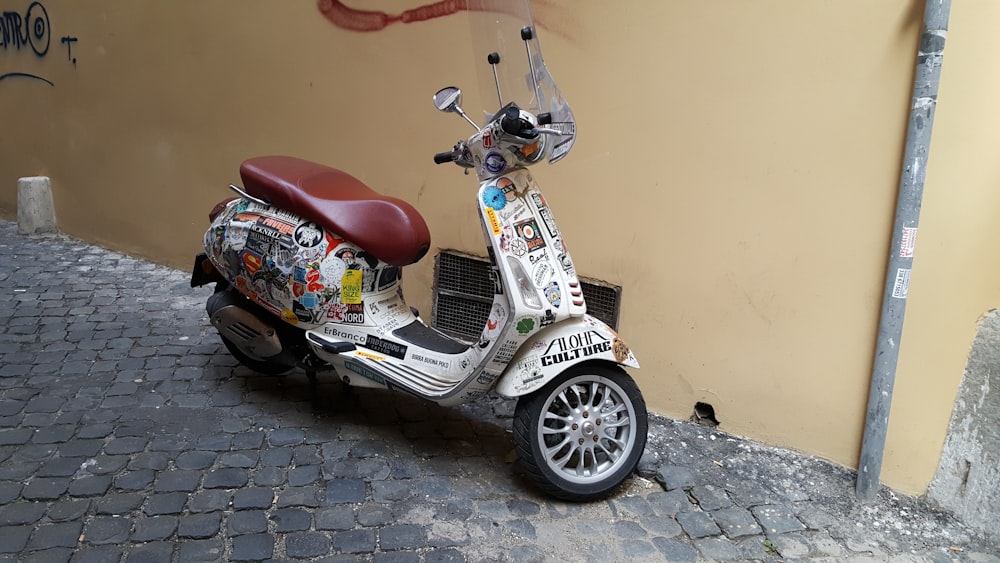 a scooter parked on the side of a building