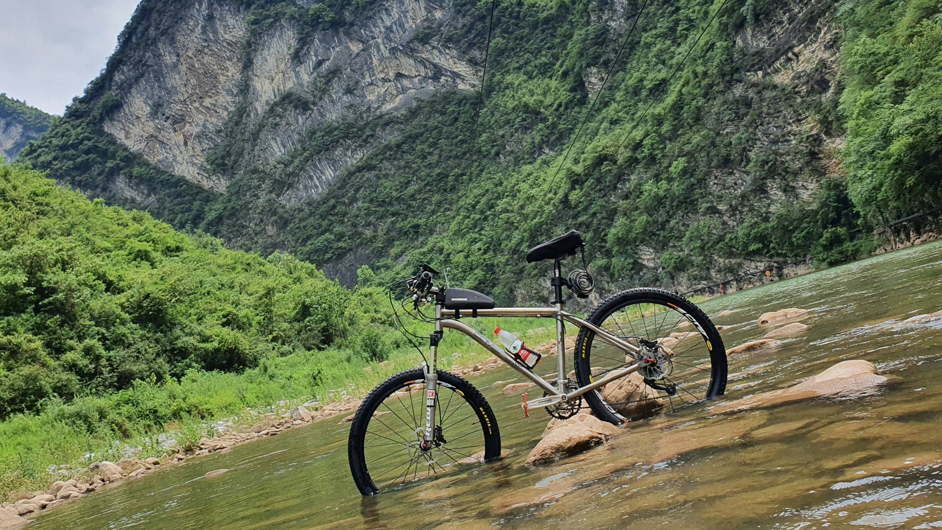 a bike parked on the side of a river